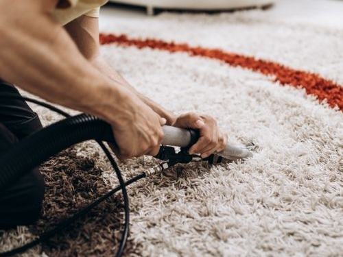 Shaggy area rug being cleaned by hand